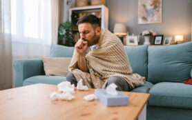 Man,Dealing,With,Flu,Symptoms,,Coughing,And,Staying,Warm,On