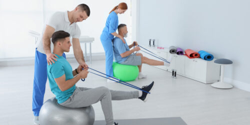 Professional Physiotherapists Working With Patients In Rehabilit