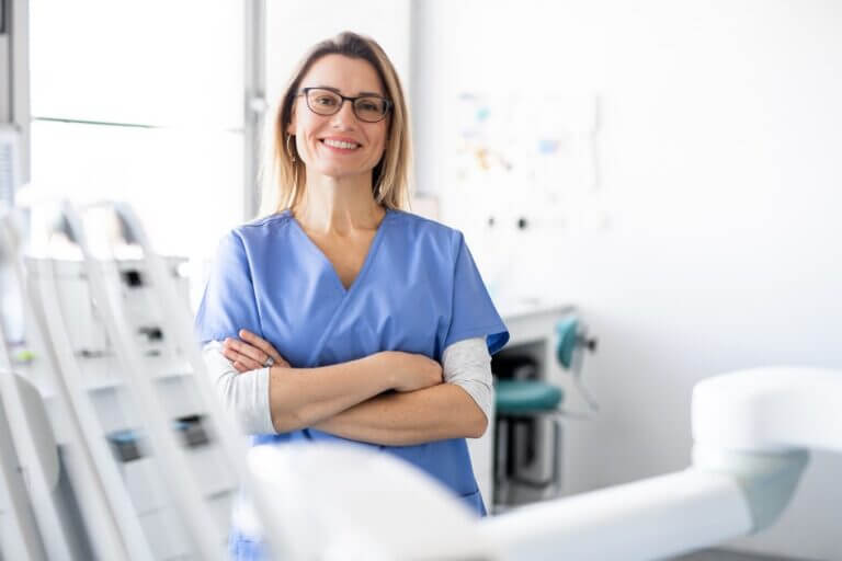 A Portrait Of Dental Assistant In Modern Dental Surgery, Looking At Camera.