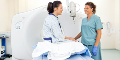 Nurse And Patient In CT Scan Room