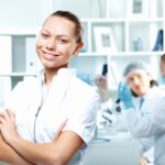 Young Scientists In White Uniform Working In Laboratory