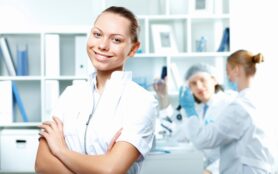 Young Scientists In White Uniform Working In Laboratory