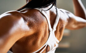 Close,Up,Of,Woman,Back,With,Flexing,Her,Muscles,In