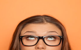Half,Portrait,Of,A,Young,Girl,With,Glasses,Looking,Up