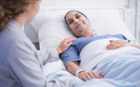 Smiling,Senior,Woman,With,A,Tumor,And,Caring,Nurse,In