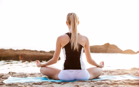 Back,View,Of,A,Young,Woman,Sitting,In,Lotus,Position
