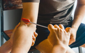 Doctor,Testing,Biceps,Tendon,Reflex,With,Red,Hummer,Jerk,On