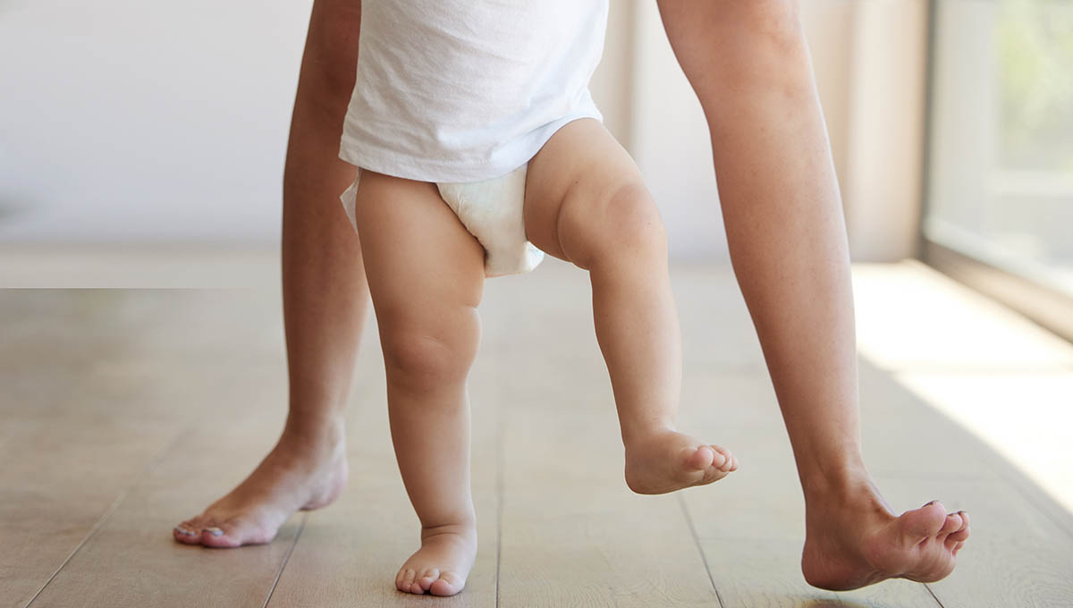 Baby,,Learning,And,Walking,With,A,Child,Taking,Its,First