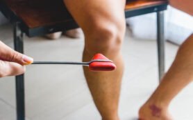 Doctor,Testing,Patellar,Reflex,Or,Knee Jerk,Reflex,With,Red,Hummer