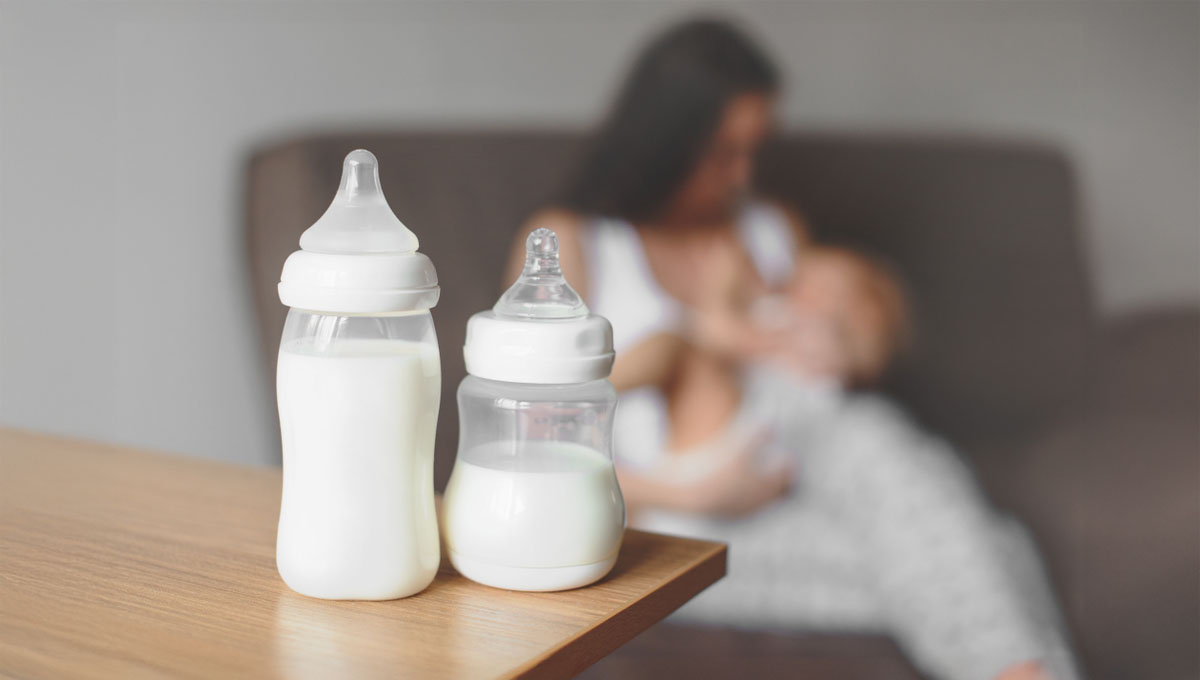 Bottles,With,Breast,Milk,On,The,Background,Of,Mother,Holding