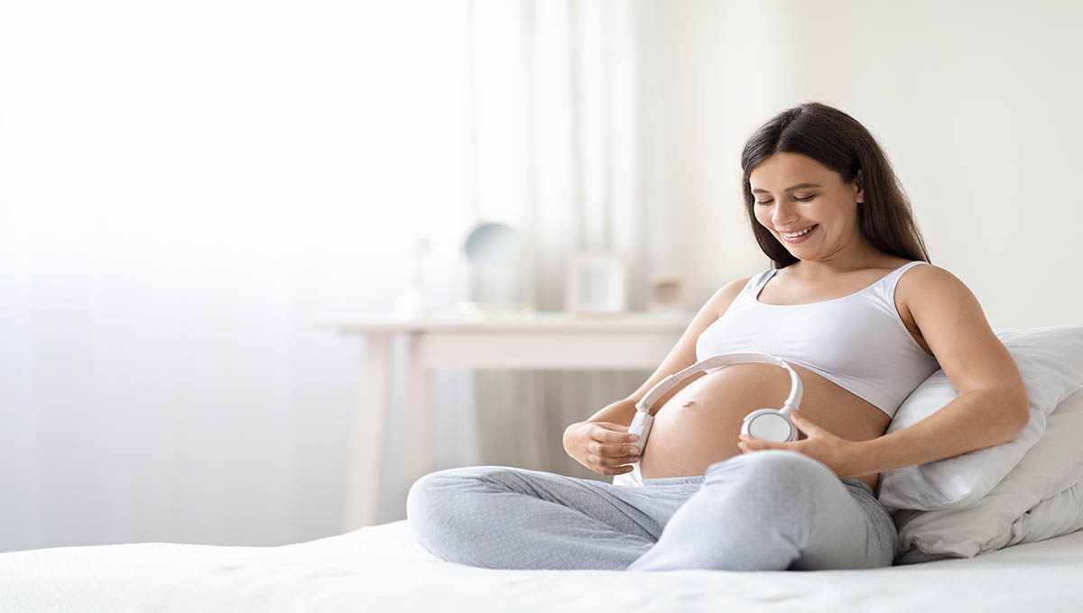 Beautiful,Pregnant,Woman,In,Comfortable,Homewear,Sitting,On,Bed,At