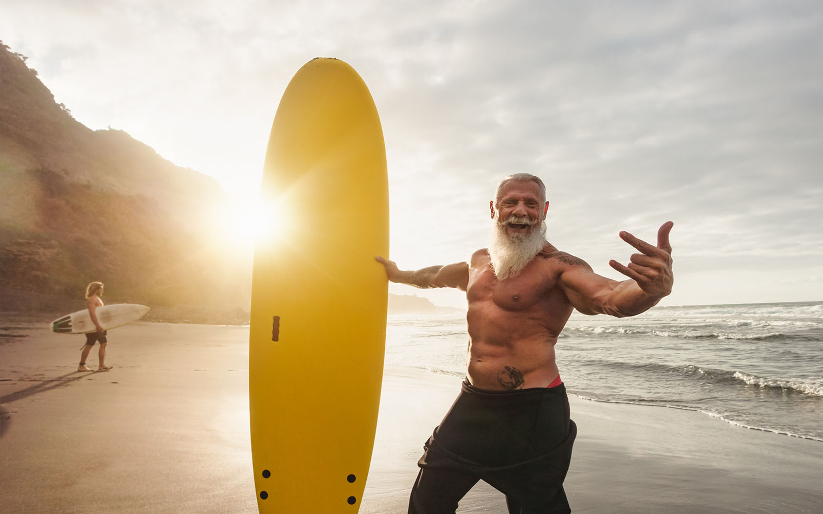 Happy,Fit,Senior,Having,Fun,Surfing,At,Sunset,Time,