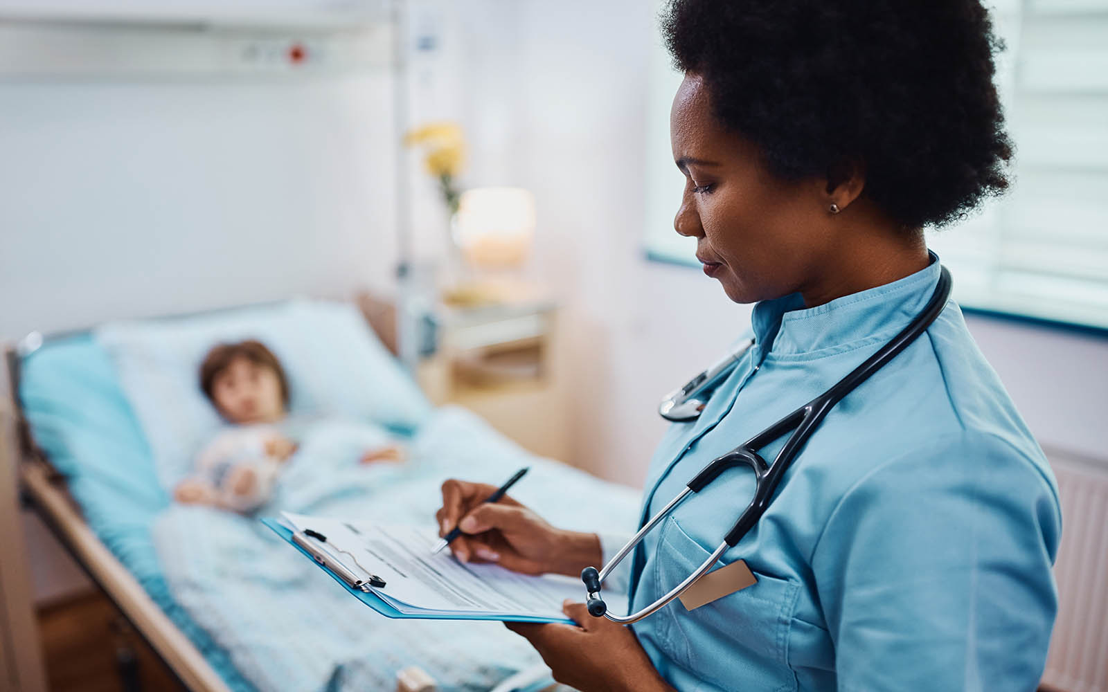 African,American,Nurse,Writing,Data,In,Medical,Record,Of,A