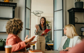Young,Female,Candidate,Walking,Into,A,Office,,Holding,A,Cv,