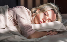 Stressed,Middle,Aged,Woman,Lying,On,Bed,At,Home,And