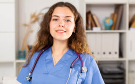 Young,Elegant,Doctor,Woman,With,A,Stethoscope,Standing,And,Smiling