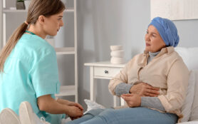 Caring,Nurse,Talks,To,Old,Patient,Holds,His,Hand,Sit