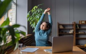 Happy,Businesswoman,Warming,Up,Body,And,Muscles,At,Workplace,,Feeling