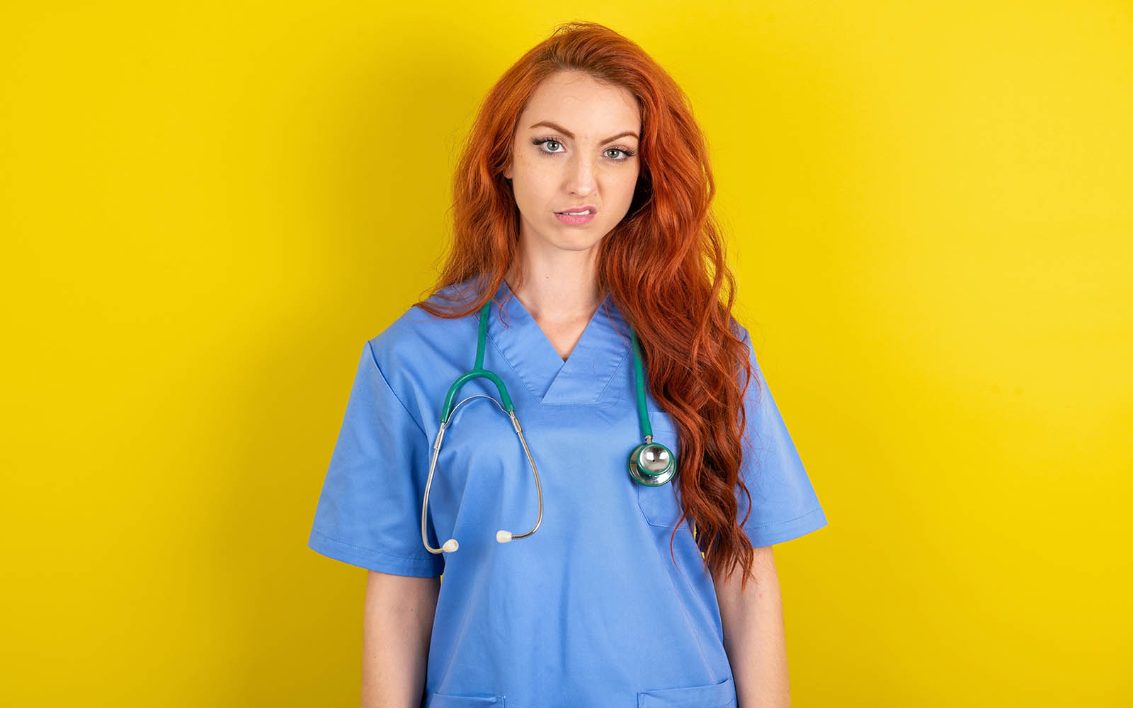Portrait,Of,Dissatisfied,Young,Red Haired,Doctor,Woman,Over,Yellow,Studio