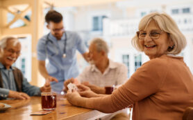 Happy,Mature,Woman,Enjoying,In,Playing,Card,With,Her,Friends